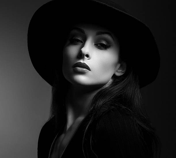istock Elegant makeup woman in fashon hat posing on dark shadow 586196112