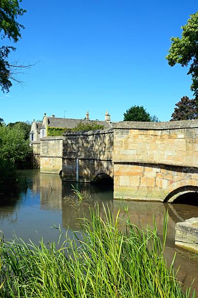 istock Medieval bridge across river Wndrush, Burford. 586196428