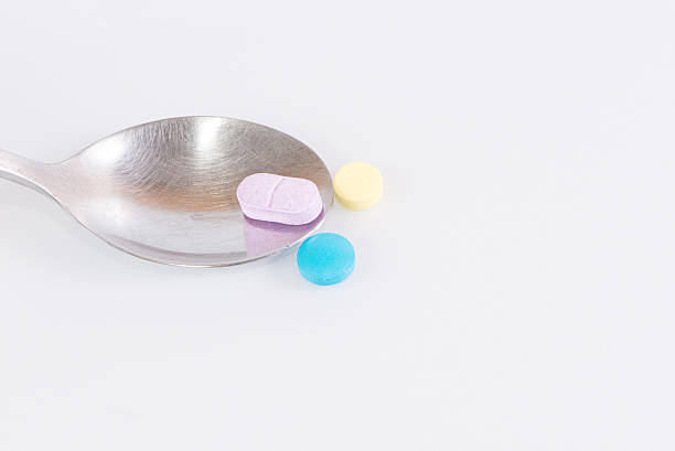 istock The medicines and spoon  isolated on a white background 586196606