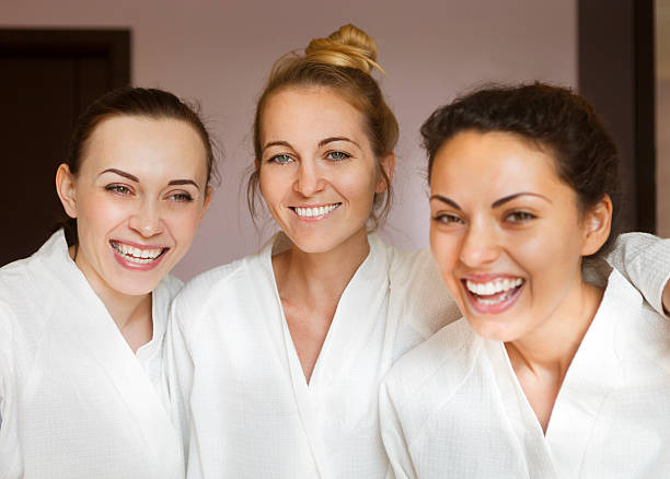 istock Three young happy women at spa resort 586198632
