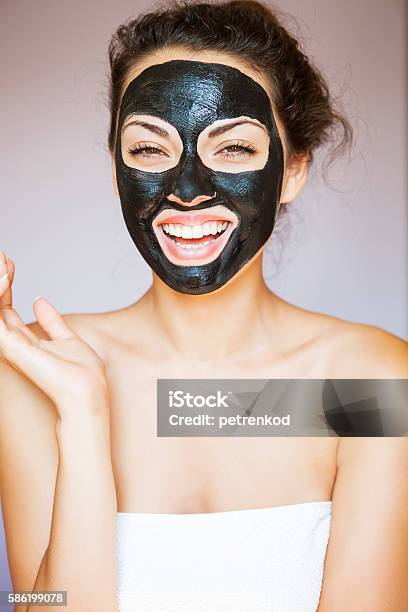 Young Woman With Face Mask Of Therapeutic Black Mud Stock Photo - Download Image Now