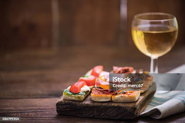 Tapas And Wine Served On Wooden Board Stock Photo - Download Image Now - Tapas, Wine, Spain