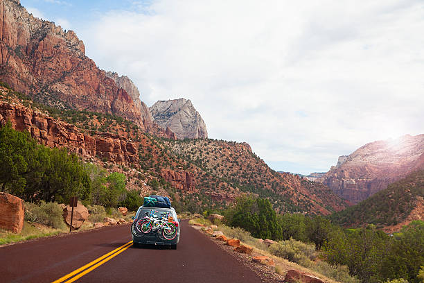 Road trip in the mountains- Utah, USA Car on the road with bicycles,  touring Utah, USA canyon road stock pictures, royalty-free photos & images