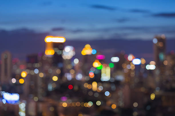 istock Abstract blurred lights city office building twilight sky 586200468