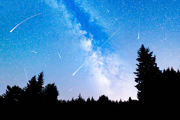istock Falling stars pine trees silhouette Milky Way 586200630