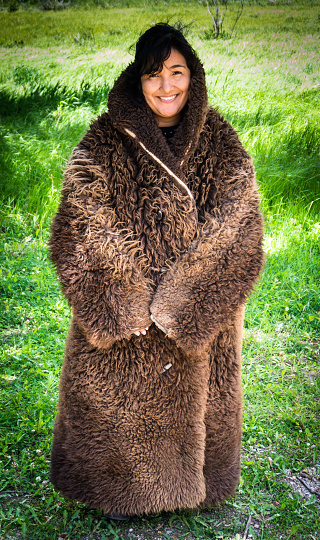 all warm and snug, young woman wearing a real buffalo coat  weighing 27 pounds 