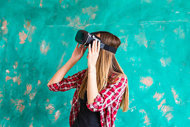istock Girl with pleasure uses head-mounted display 586203576