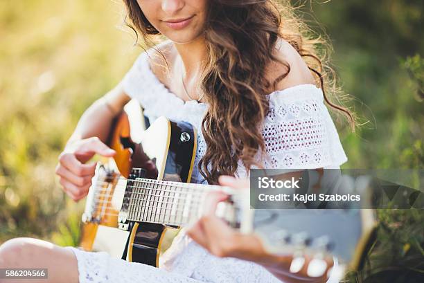 Girl Playing A Guitar In Nature Stock Photo - Download Image Now - Guitar, Adult, Agricultural Field