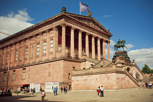 Berlin, Germany - September 2, 2015: People walking around great structure of Alte Nationalgalerie on Septemper 2, 2015. Old National Gallery located on Museum Island, a UNESCO World Heritage Site