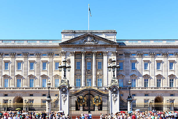 London, UK - July 19, 2016 - Buckingham Palace in London with a crowd of tourists outside on a cloudless day