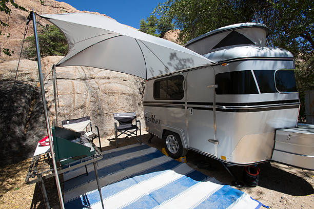 The Meerkat tiny camper is setup with awning stock photo