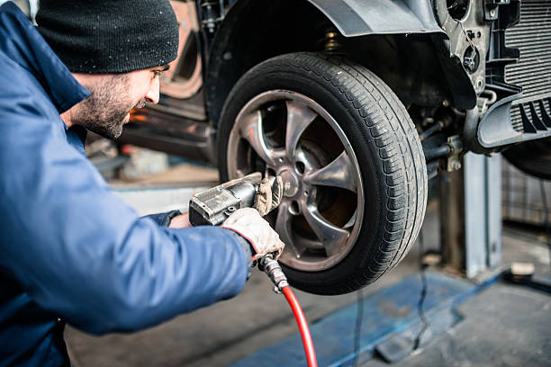 istock tire repairer changing the car tire 586208762