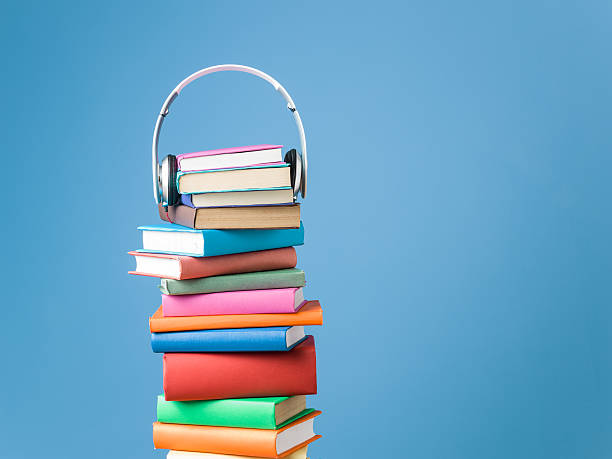 Headphones On Top Of Multicolored Hardcover Books For Audio Reading stock photo