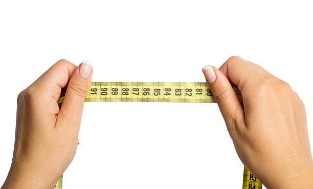 istock woman hands with measure tape 586346674