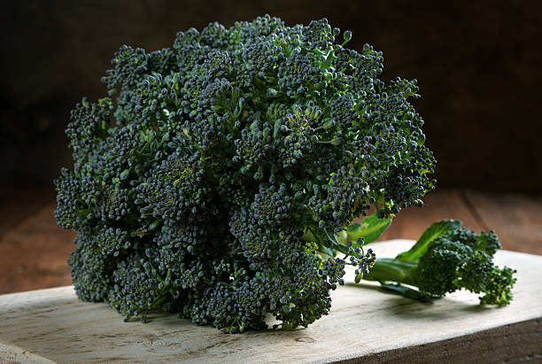 istock head of broccoli with leaves in a table 586347152
