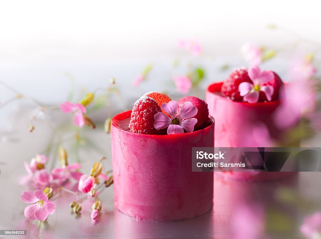 Raspberry mousse cakes Raspberry mousse cakes with fresh berries and macaroni Baked Pastry Item Stock Photo