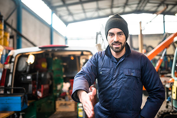 mechanic technician on a garage give the handshake mechanic technician on a garage car portrait men expertise stock pictures, royalty-free photos & images