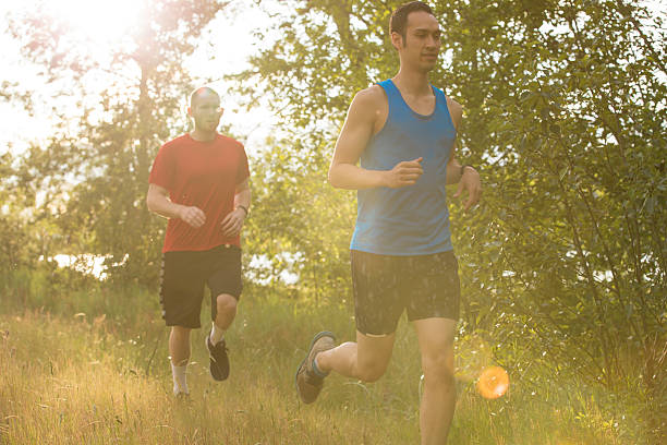 istock Young men running together on a trail in the evening. 586348902