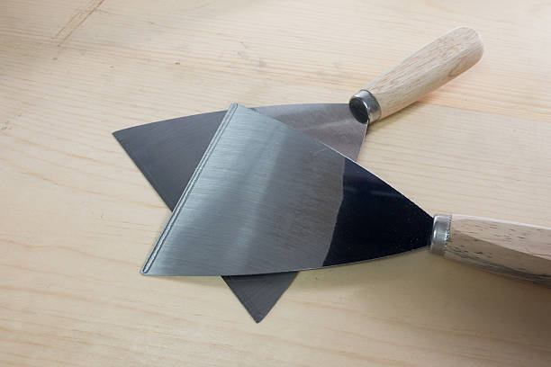 istock steel putty spattles with wooden handles. 586351384