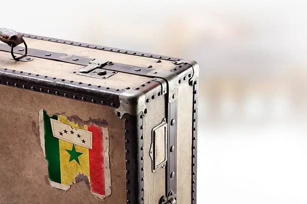 Photo of Old leather suitcase with flag of Senegal