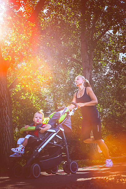 istock Jogger mom with baby in stroller 586352548