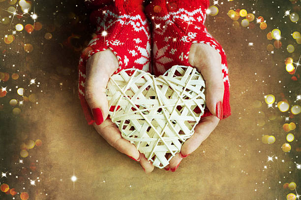 istock Christmas heart  in woman hands 586353250