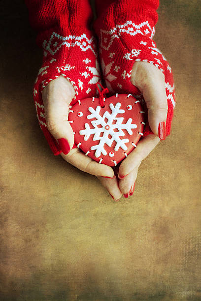 istock Christmas heart  in woman hands 586353394