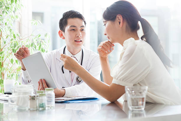 patients are looking at test results of doctor and tablet - x ray image radiologist examining using voice imagens e fotografias de stock