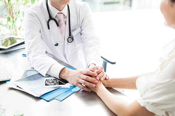 doctor holding the hand of the patient in hospital - x ray image radiologist examining using voice imagens e fotografias de stock