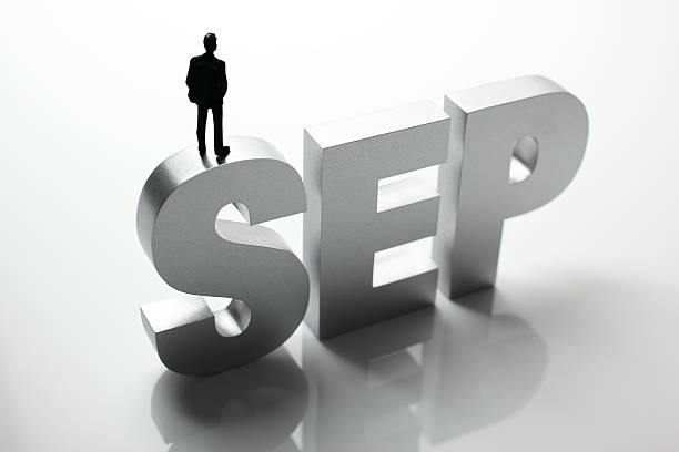 istock Figurine Businessman Standing on Big Letters SEP 586355664