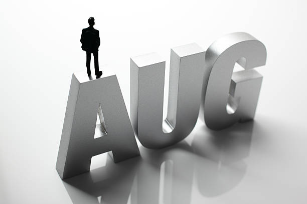 istock Figurine Businessman Standing on Big Letters AUG 586355786