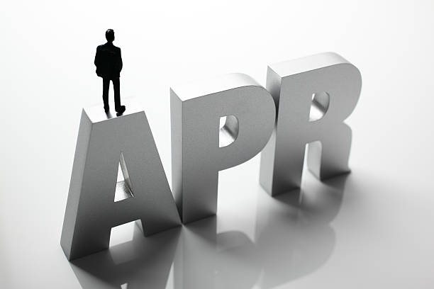 istock Figurine Businessman Standing on Big Letters APR 586355802