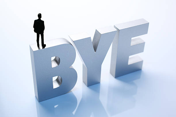 istock Figurine Businessman Standing on Big Letters BYE 586356156