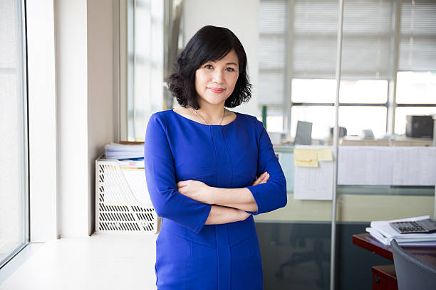 successful chinese business woman mature, middle-aged woman is a successful business person civil servant stock pictures, royalty-free photos & images
