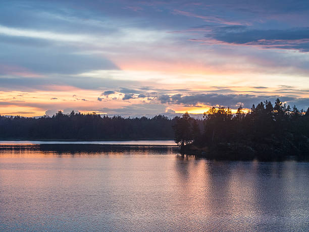 istock sunset over the forest lake 586356722