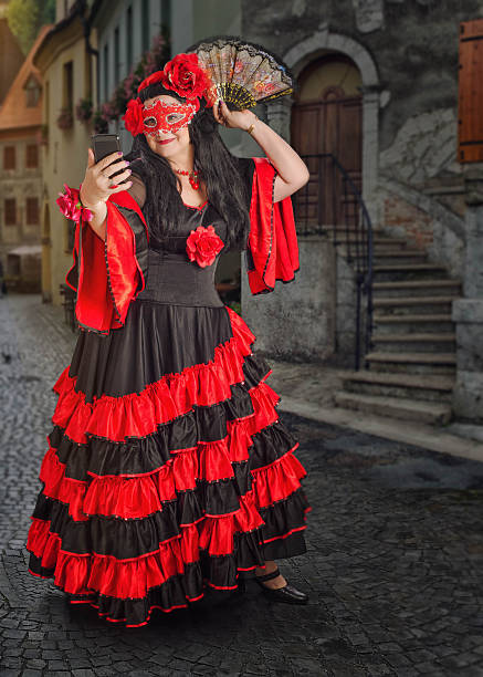 istock Masked flamenco female dancer taking selfie 586356894