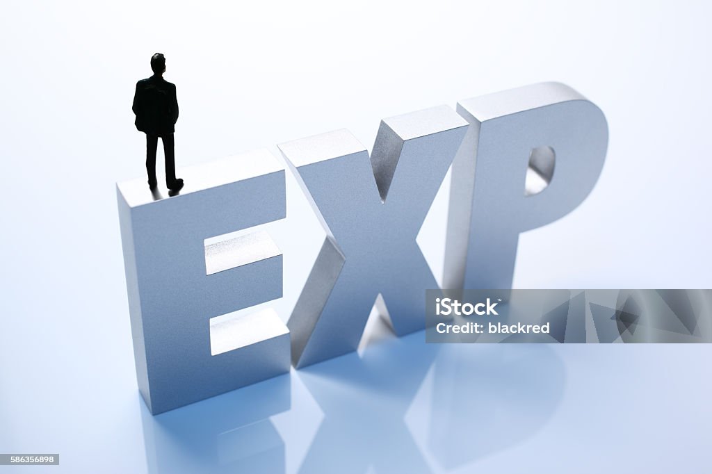Figurine Businessman Standing on Big Letters EXP Adult Stock Photo