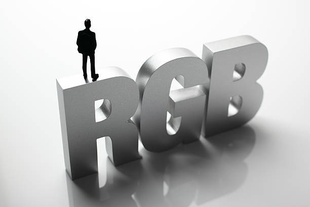 istock Figurine Businessman Standing on Big Letters RGB 586357376