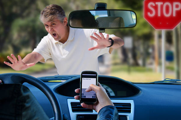 Texting and driving wreck hitting pedestrian An irresponsible texting driver is about to run over a pedestrian at an intersection which shows how dangerous texting and driving is. Stop the text and stop the wrecks. pedestrian stock pictures, royalty-free photos & images