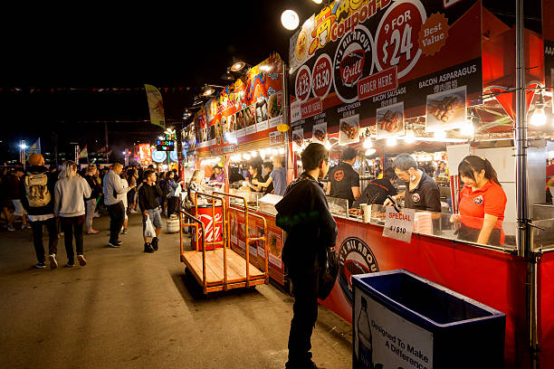Richmond Summer Night Market Richmond, Canada - July 10, 2016: Visitors at the Richmond night market near Vancouver enjoying food and fun. The summer market attracts visitors from around the world for its ethnic food, unique shops and nightly street entertainment. night market stock pictures, royalty-free photos & images