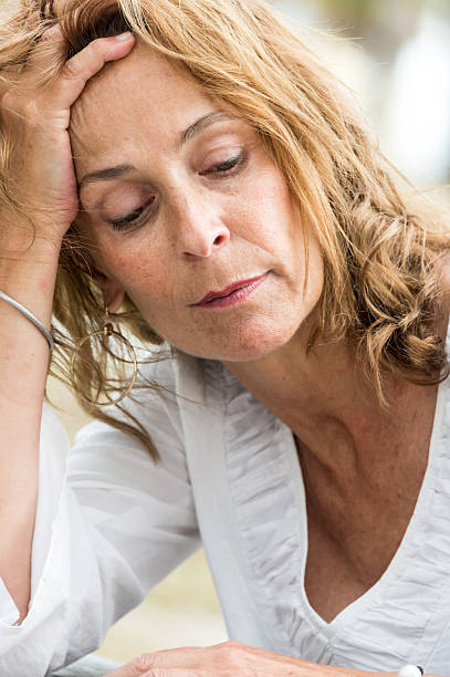 istock Depressed fifty something woman 586358434