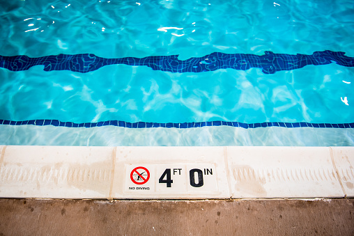 Swimming pool no diving and depth warning sign