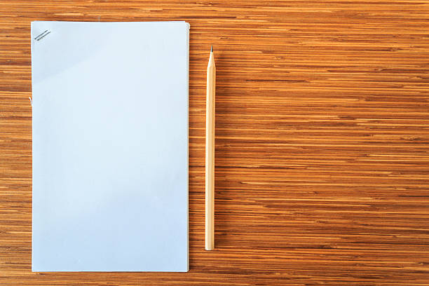 istock paper note and pencil on wood background 586360566