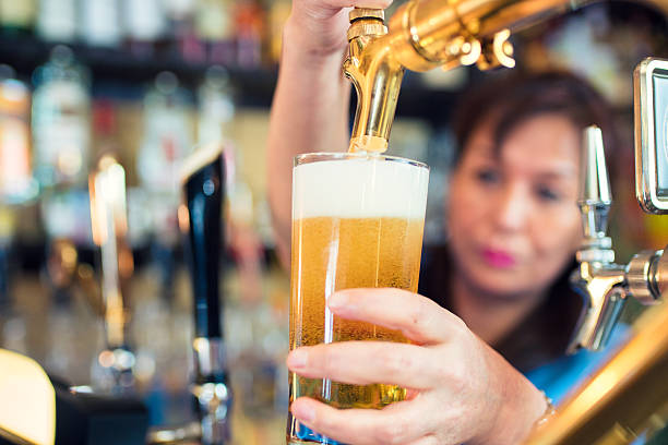 istock Bartender pouring a pint of beer 586361270