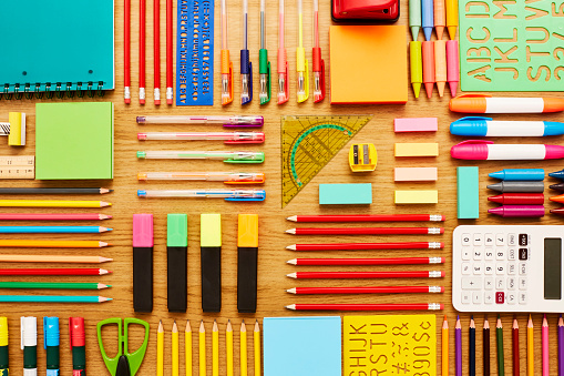 Directly above shot of office and school supplies. Full frame shot of stationery arranged on wooden surface. Knolling Concept.