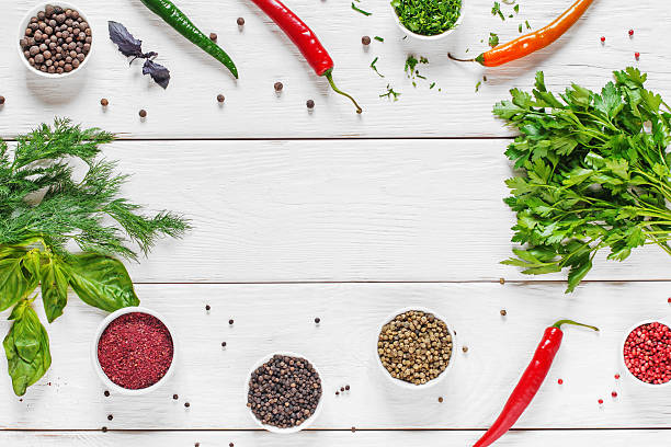 istock Frame of herbs and spices on white wood, flat lay 586364062