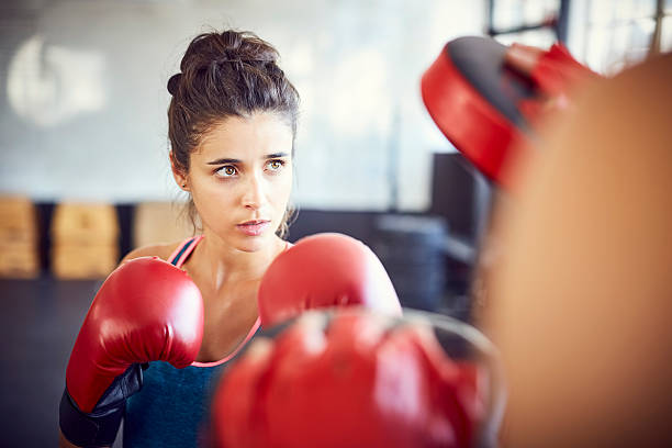 istock Confident female fit boxer practicing in gym 586364306