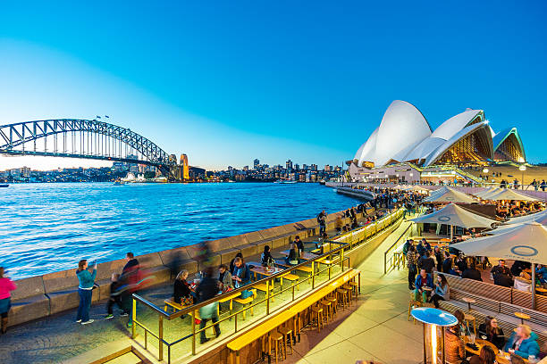 les gens dînant dans des restaurants en plein air à circular quay à sydney - sydney opera house opera house sydney australia sydney harbor photos et images de collection