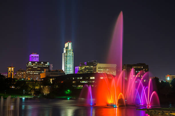 omaha skyline mit brunnen bei nacht - omaha nebraska nebraska night downtown district stock-fotos und bilder