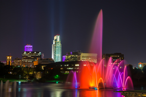 Downtown Omaha skyline with a beautifully lit fountain at night.